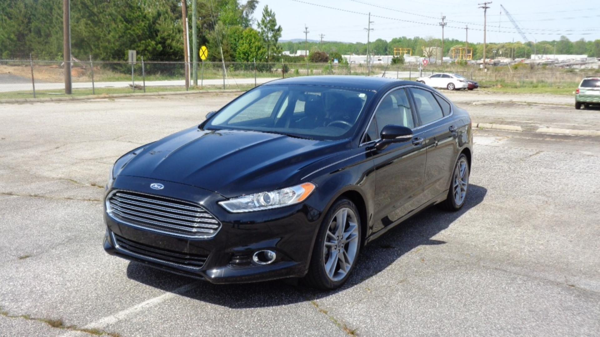 2016 BLACK /BLACK Ford Fusion Titanium (3FA6P0K99GR) with an 2.0L L4 DOHC 16V engine, 6-Speed Automatic transmission, located at 2812 White Horse Road, Greenville, SC, 29611, (864) 269-1711, 34.808655, -82.434776 - 3.6 LITER V6 ENGINE, 22 INCH BLACK RIMS W/ NEW SET OF TIRES,ANTI LOCK BRAKES,TILT/REACH STEERING,A/C,DUAL AIRBAGS,FRONT SIDE AIRBAGS,BODY COLOR BUMPERS,MIRRORS,AND DOOR HANDLES,CRUISE CONTROL, FOG LIGHTS ,AUTOMATIC HEADLIGHTS,USB/AUX OUTLET,VANITY MIRRORS,TRACTION COTNROL,POWER MIRRORS,WINDOWS,AND D - Photo#0