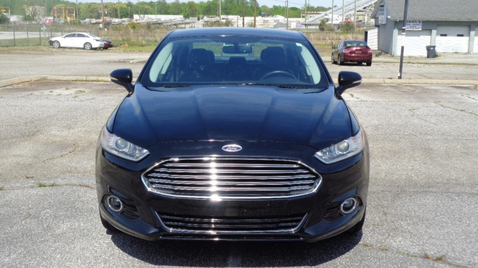 2016 BLACK /BLACK Ford Fusion Titanium (3FA6P0K99GR) with an 2.0L L4 DOHC 16V engine, 6-Speed Automatic transmission, located at 2812 White Horse Road, Greenville, SC, 29611, (864) 269-1711, 34.808655, -82.434776 - 3.6 LITER V6 ENGINE, 22 INCH BLACK RIMS W/ NEW SET OF TIRES,ANTI LOCK BRAKES,TILT/REACH STEERING,A/C,DUAL AIRBAGS,FRONT SIDE AIRBAGS,BODY COLOR BUMPERS,MIRRORS,AND DOOR HANDLES,CRUISE CONTROL, FOG LIGHTS ,AUTOMATIC HEADLIGHTS,USB/AUX OUTLET,VANITY MIRRORS,TRACTION COTNROL,POWER MIRRORS,WINDOWS,AND D - Photo#1