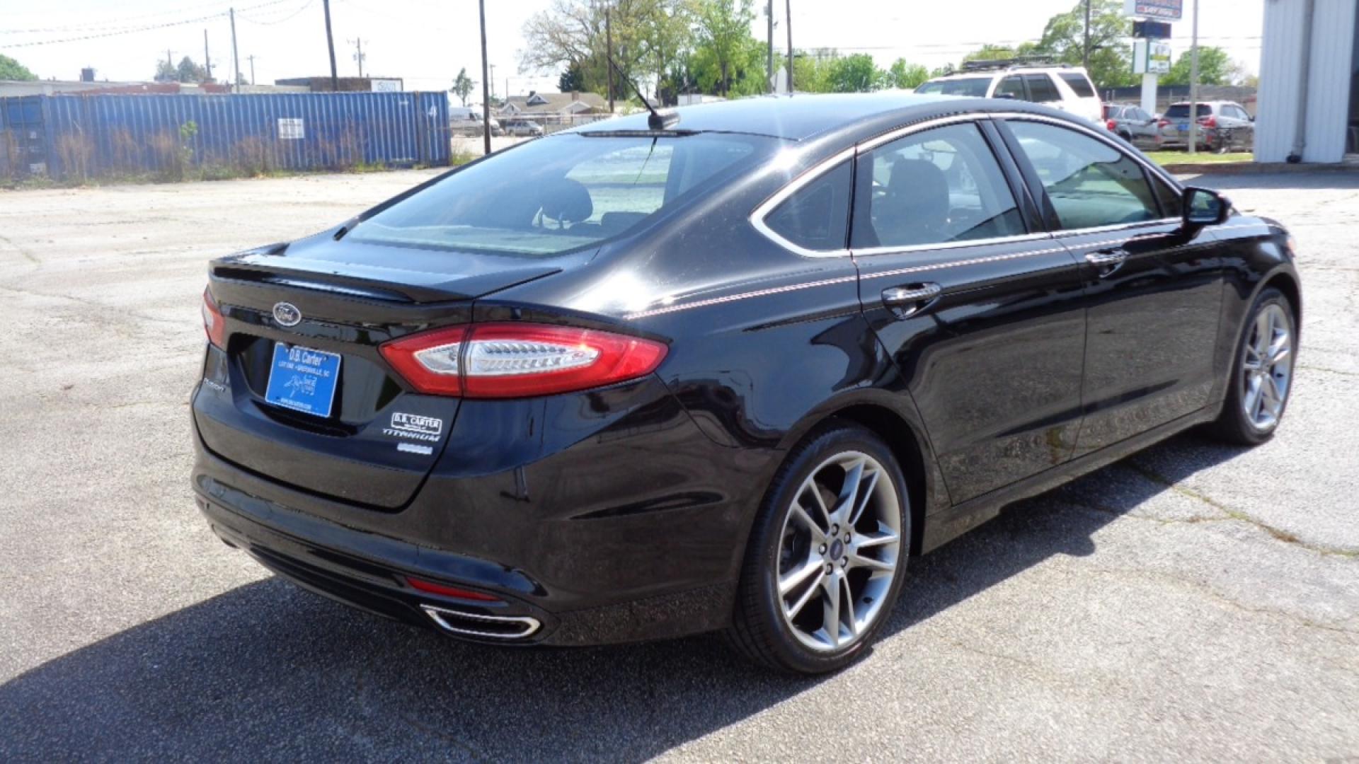 2016 BLACK /BLACK Ford Fusion Titanium (3FA6P0K99GR) with an 2.0L L4 DOHC 16V engine, 6-Speed Automatic transmission, located at 2812 White Horse Road, Greenville, SC, 29611, (864) 269-1711, 34.808655, -82.434776 - 3.6 LITER V6 ENGINE, 22 INCH BLACK RIMS W/ NEW SET OF TIRES,ANTI LOCK BRAKES,TILT/REACH STEERING,A/C,DUAL AIRBAGS,FRONT SIDE AIRBAGS,BODY COLOR BUMPERS,MIRRORS,AND DOOR HANDLES,CRUISE CONTROL, FOG LIGHTS ,AUTOMATIC HEADLIGHTS,USB/AUX OUTLET,VANITY MIRRORS,TRACTION COTNROL,POWER MIRRORS,WINDOWS,AND D - Photo#3