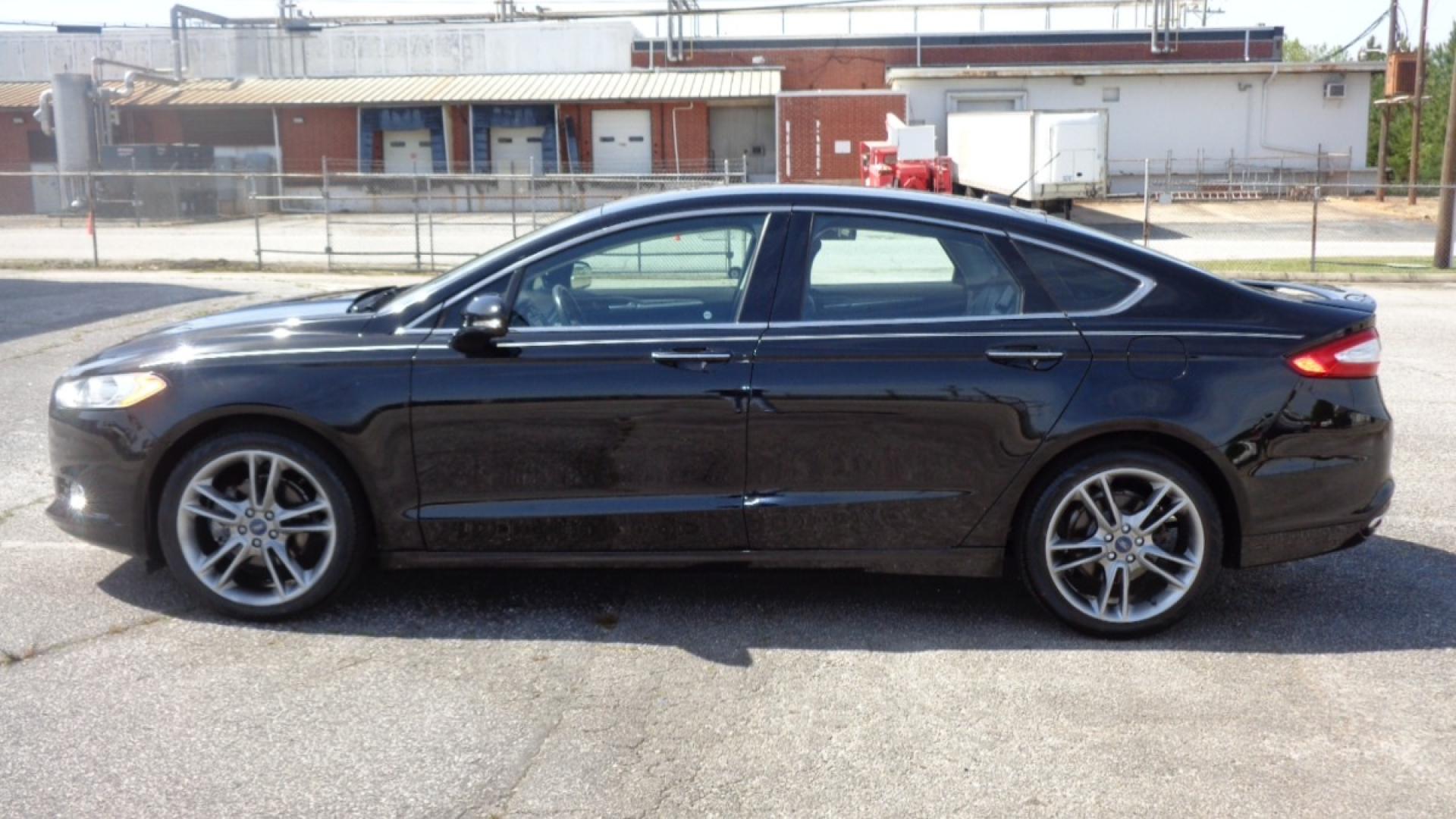 2016 BLACK /BLACK Ford Fusion Titanium (3FA6P0K99GR) with an 2.0L L4 DOHC 16V engine, 6-Speed Automatic transmission, located at 2812 White Horse Road, Greenville, SC, 29611, (864) 269-1711, 34.808655, -82.434776 - 3.6 LITER V6 ENGINE, 22 INCH BLACK RIMS W/ NEW SET OF TIRES,ANTI LOCK BRAKES,TILT/REACH STEERING,A/C,DUAL AIRBAGS,FRONT SIDE AIRBAGS,BODY COLOR BUMPERS,MIRRORS,AND DOOR HANDLES,CRUISE CONTROL, FOG LIGHTS ,AUTOMATIC HEADLIGHTS,USB/AUX OUTLET,VANITY MIRRORS,TRACTION COTNROL,POWER MIRRORS,WINDOWS,AND D - Photo#5